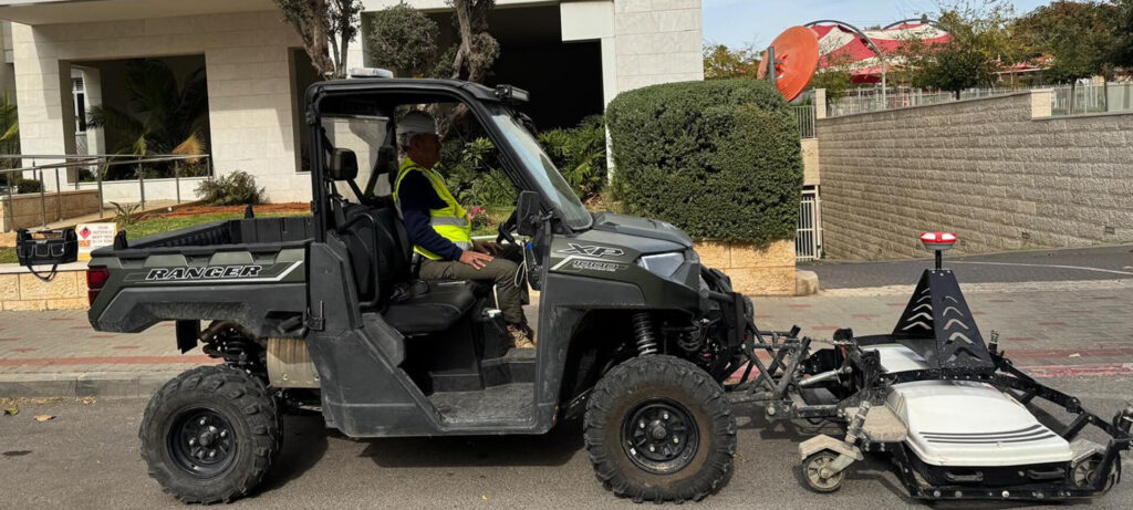 Side view of a Maya Global utility vehicle towing an advanced multi-channel Ground Penetrating Radar (GPR) array on an urban street, highlighting special technologies for rapid subsurface utility mapping.
